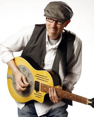 Mark Bruner playing guitar, white background